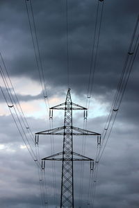 Low angle view of electricity pylon against sky