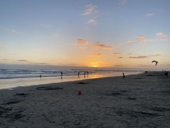 Scenic view of beach against sky during sunset