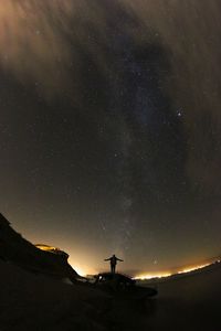 Low angle view of silhouette mountain against sky at night