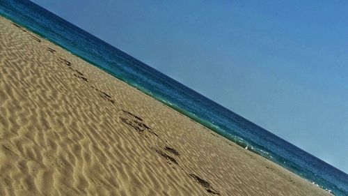 Scenic view of sea against blue sky