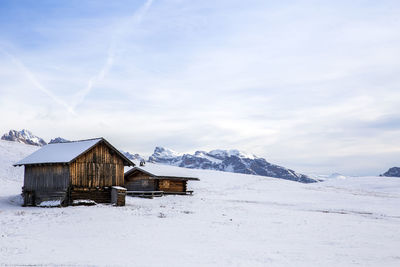 Scenic view of snow covered field against mountains