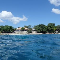 Scenic view of swimming pool by sea against sky