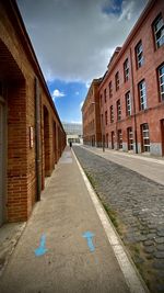 Empty alley amidst buildings in city