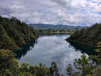 Scenic view of lake and mountains against sky