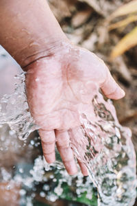 High angle view of human hand in water