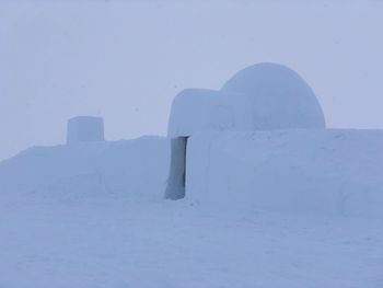 Stone wall against clear sky during winter