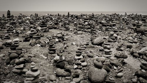 View of pebbles on beach against sky