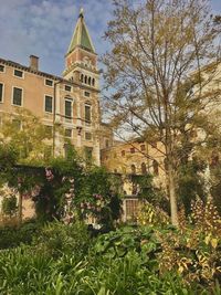 Historic building by trees against sky