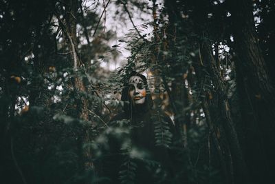 Woman standing in forest