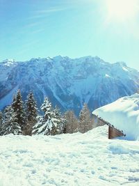 Scenic view of snowcapped mountains against blue sky