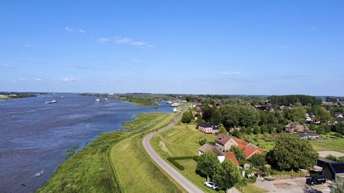 High angle view of townscape by sea against sky