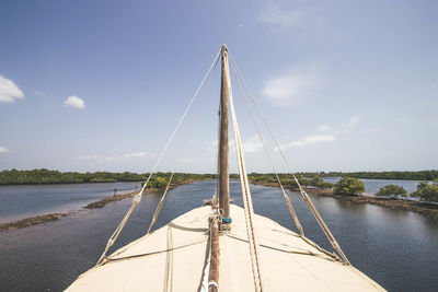 Sailboat sailing on sea against sky