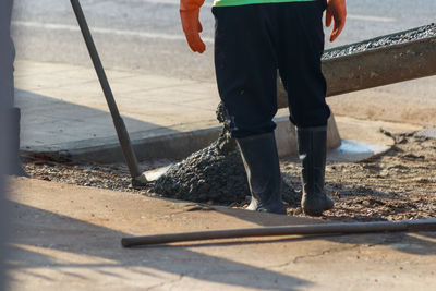 Low section of man working on sand