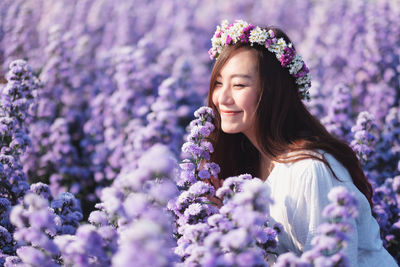 Portrait of smiling woman with purple flower