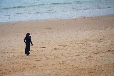 Full length of woman walking on beach