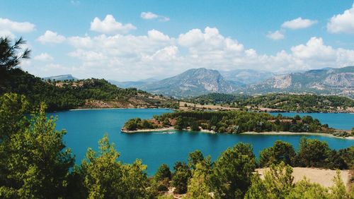 Scenic view of calm lake against cloudy sky