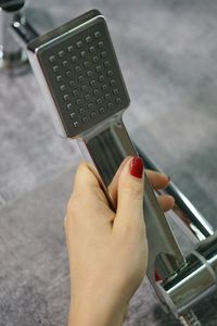 Close-up of woman hand holding camera on table