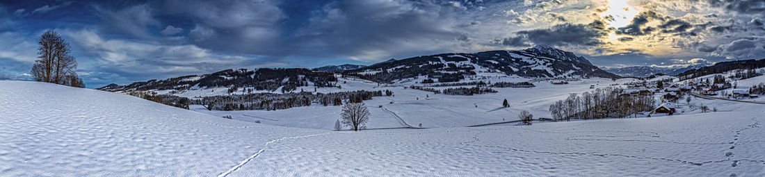 Scenic view of snowcapped mountains against sky