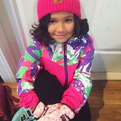 Portrait of smiling girl sitting at home