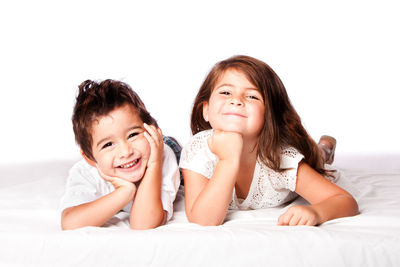 Portrait of smiling girl lying on bed