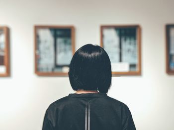 Rear view of boy standing at home