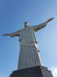 Low angle view of statue against blue sky