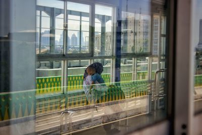 Full length of woman seen through glass window