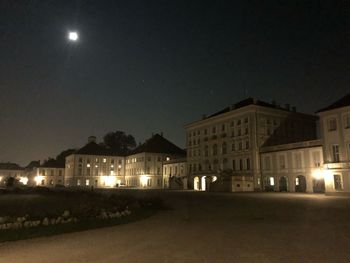 Illuminated buildings against sky at night