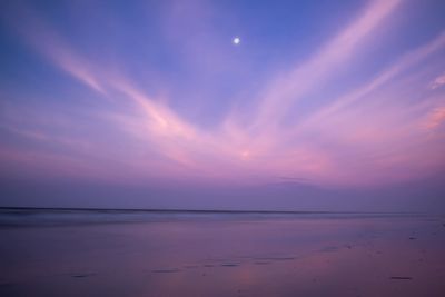 Scenic view of sea against sky at sunset