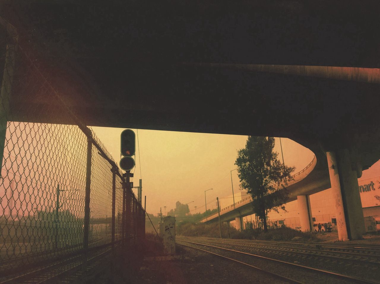 railroad track, transportation, built structure, architecture, rail transportation, building exterior, the way forward, metal, connection, railing, public transportation, sky, no people, sunlight, road, diminishing perspective, fence, bridge - man made structure, clear sky, railroad station