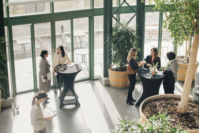 High angle view of female professionals discussing in event