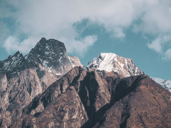 Low angle view of snowcapped mountain against sky