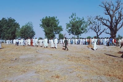 Panoramic view of people against clear sky