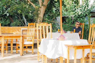 Midsection of woman on table in restaurant