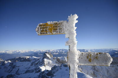 Snow covered mountain against blue sky