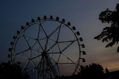 Low angle view of ferris wheel against sky