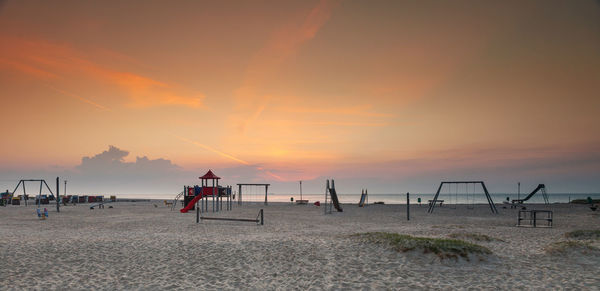 Scenic view of beach against sky during sunset