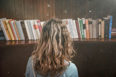 Rear view of woman in library