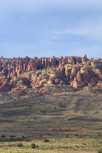 Rock formations on landscape against sky