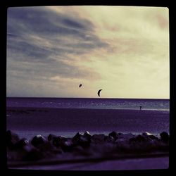 Scenic view of sea against cloudy sky