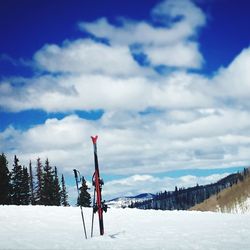 Man on snow covered mountain against sky