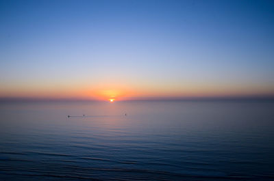 Scenic view of sea against clear sky during sunset