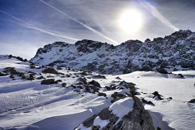 Scenic view of snow covered mountains against sky