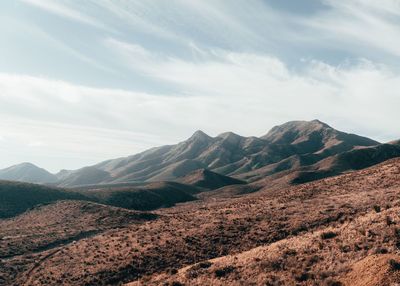 Scenic view of mountains against cloudy sky