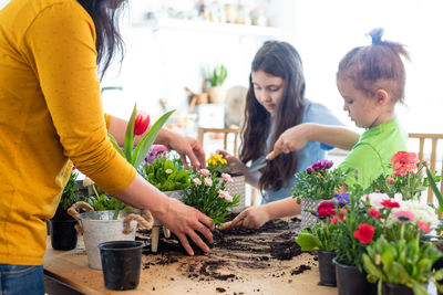 Rear view of people with daughter against plants