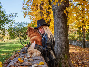 Pretty blond girl play with pomeranian dog