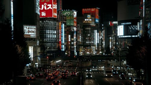 Illuminated city street and buildings at night