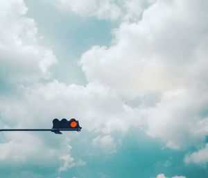 Low angle view of traffic signal against sky