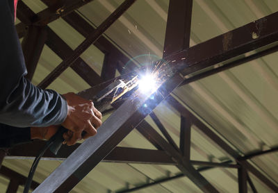 Low angle view of man working at construction site