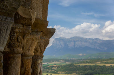 Scenic view of mountains against cloudy sky